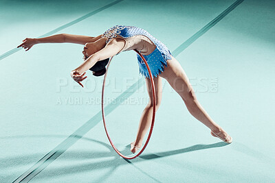 Buy stock photo Sports woman, performance and balance ring for gymnastics show. Fitness girl doing artistic pose and stretch for acrobat stunt. Young and beautiful athlete in gym with hula hoop and flexible body.