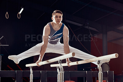 Buy stock photo Gym, man and training for balance and fitness in professional gymnastics for cardio sports workout at night. Young athletic guy in dark competitive acrobat exercise in sport practice for competition.