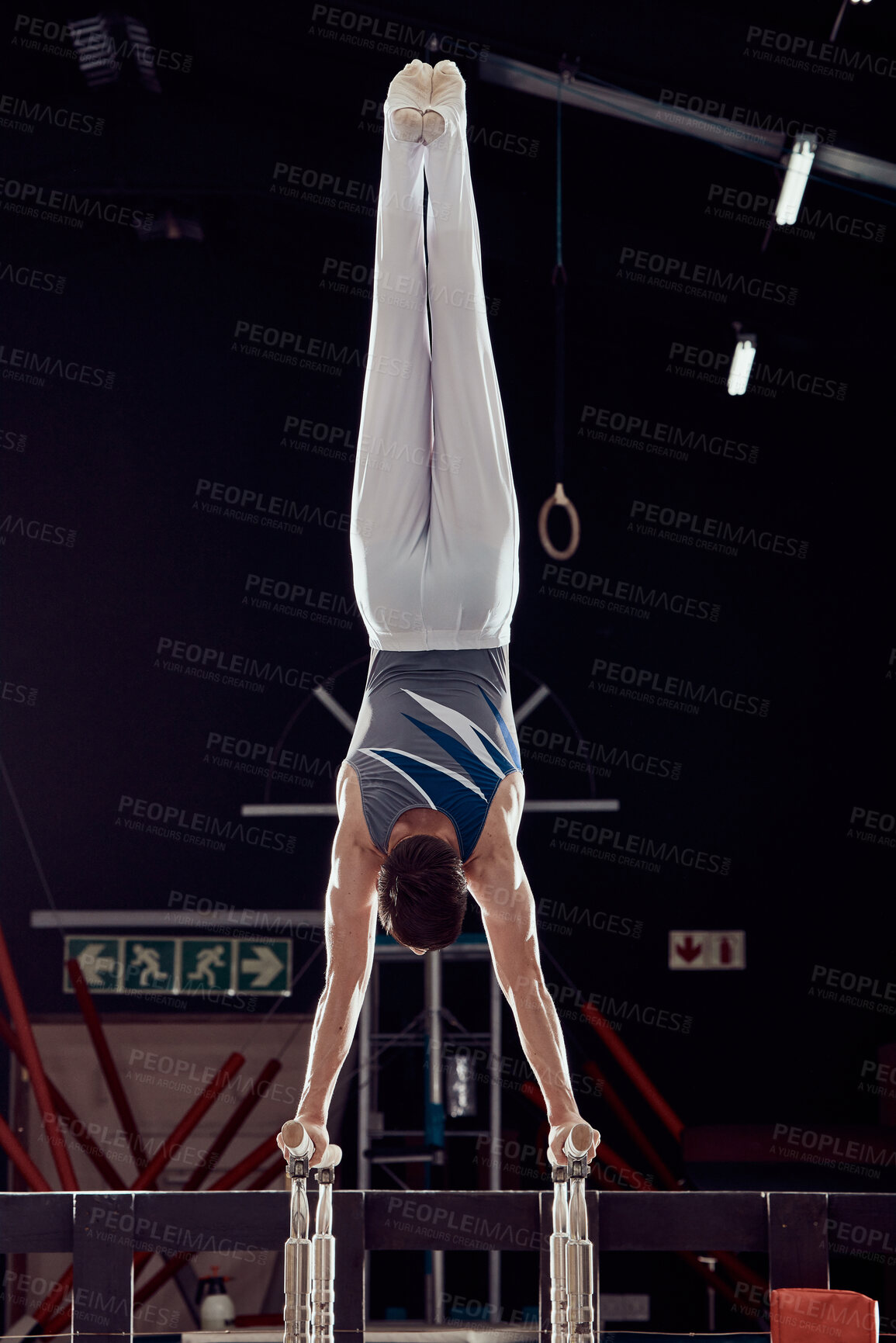 Buy stock photo Strong man training for fitness in gym, cardio sports exercise at stadium at night and sport workout for health and wellness in dark arena. Young athlete person doing gymnastics in competition