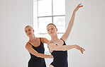 Creative, ballet and dance teacher with ballerina teaching posture in a modern studio. Woman instructor and fit, elegant and flexible dancer training and dancing in a studio, art school or class
