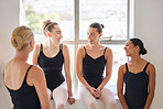Friendship, support and happy ballet dancer group bonding on a break to relax from training in a dance studio. Diverse women laughing and enjoying time together, discussing creative rehearsal plans