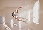 Woman ballet dancer dancing in a dance studio mockup white walls and sunlight. Young professional girl, art or sports student jumping mid air technique in a creative ballerina class