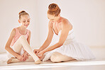 Ballet coach, dance and student training of a young ballerina and dancing teacher help. Exercise and dancer workout of a girl and tutor helping with her shoes for a creative stage show performance