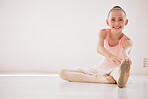 Happy ballet dancer girl stretching on the floor in a dance studio with mockup white background. Portrait and smile on kid face while learning or training with legs in class for a performance mock up