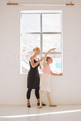 Ballet student and teaching coach in dance class for kids art school and coaching or learning in professional studio by the window. Girl dancer training, stretching body with help, support of teacher