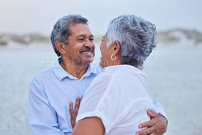 Buy stock photo Senior, love and couple hug in nature at lake or beach on retirement holiday with a smile looking into eyes. Happy, romance and elderly man and woman enjoying sea or marriage anniversary or vacation.