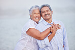 Senior love, hug and portrait couple on beach in trust hug, security and safety on retirement holiday, vacation or break. Happy couple, people smile and elderly man and woman bonding close together
