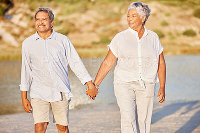 Beach, love and retirement, a senior couple holding hands and walking in the sand. Health, sunshine and recreation for an elderly man and woman to relax and enjoy. A happy time together by the water.