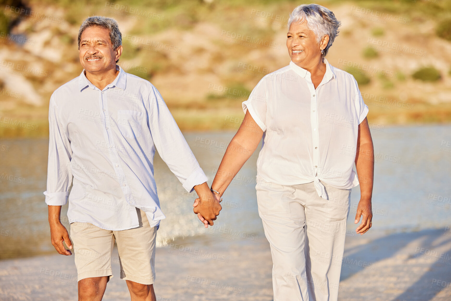 Buy stock photo Beach, love and retirement, a senior couple holding hands and walking in the sand. Health, sunshine and recreation for an elderly man and woman to relax and enjoy. A happy time together by the water.