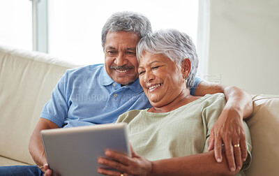 Buy stock photo Senior couple, tablet and communication on social media or video call with elderly husband and wife relaxing on the couch at home. Man and woman reading retirement savings insurance on a banking app