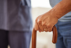 Support, physiotherapy and disability patient hold walking stick or cane, practice recovery with physical therapist or nurse. Senior man suffering from Parkinson, assisted living retirement facility