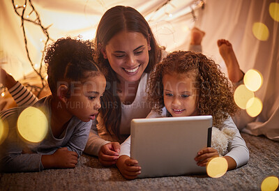 Buy stock photo Home tent mother and kids on tablet watch movie or online children entertainment movies at night at house. Happy smile mom or woman and young girl youth family watching or playing fun internet games