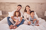 Family portrait on bed and happy mother, father and children wake up in the morning together with happy smile on face in their bedroom home. Happiness of mom and dad with kids while they relax