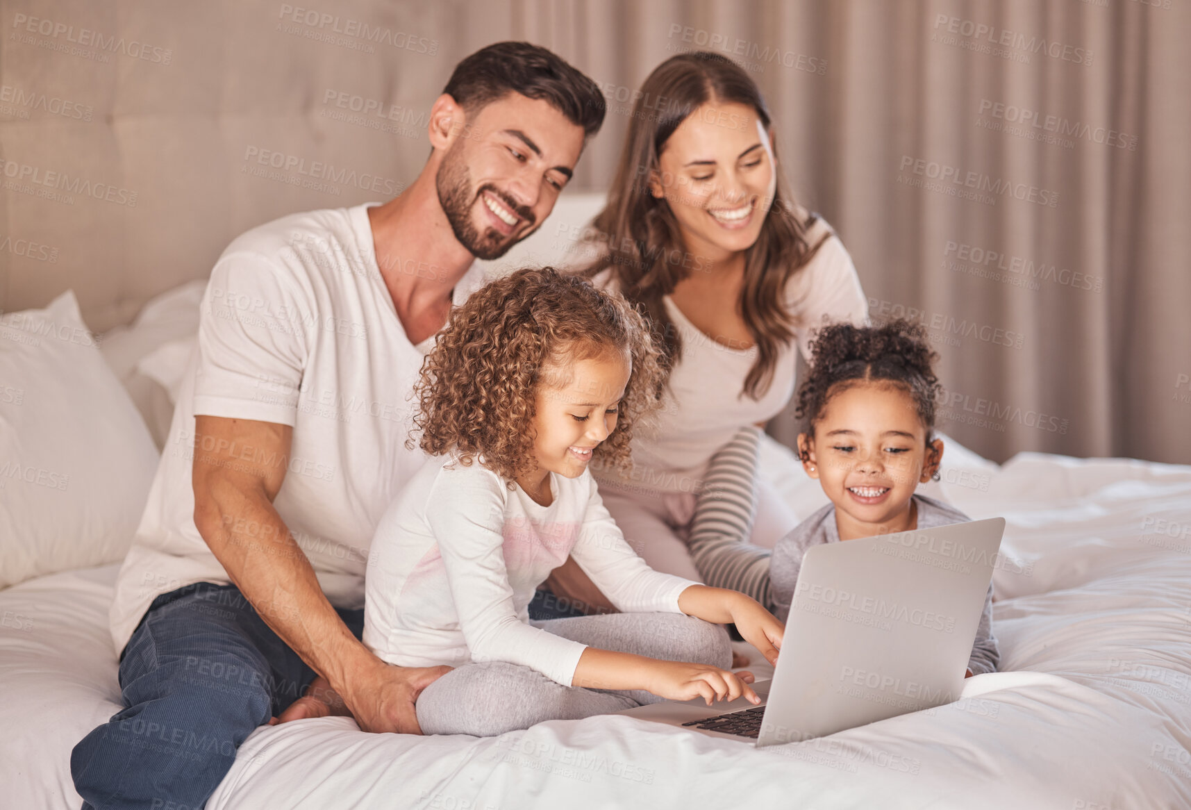 Buy stock photo Family, laptop and relax on bed together with kids for bonding time. Caring home, parents and young daughters with happy relationship. Smiling couple and children having quality time while relaxing.