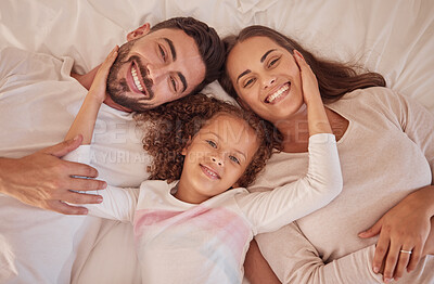 Buy stock photo Portrait of happy love parents and daughter with smile in bed while relax in the morning. Family or mom, dad and child lying in bedroom having playful fun and bonding with happiness at home together