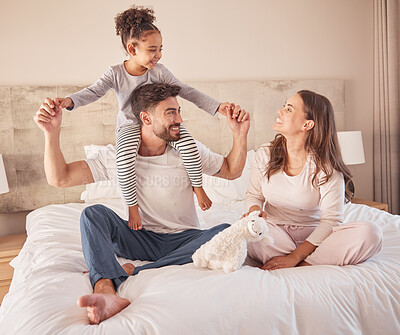 Buy stock photo Happy family while playing and fun in bed at home together in the morning. Mother, father and girl or daughter laughing and playful fun with love in the bedroom at home while bonding together