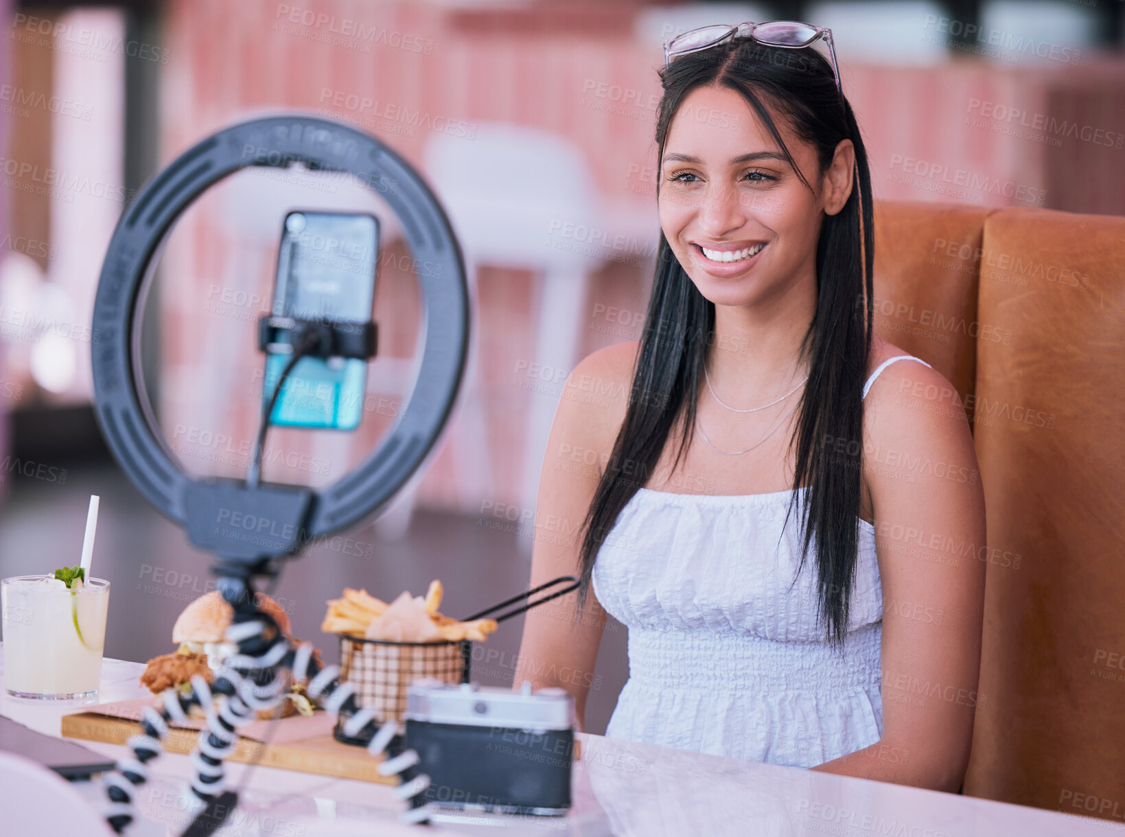 Buy stock photo Social media influencer online video of food at cafe, smartphone technology with mobile light lifestyle vlog. Happy young girl in restaurant with film camera, woman eating fries, burger and cocktail