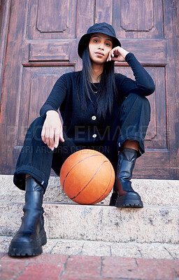 Buy stock photo Basketball, fashion and model influencer of a woman posing on steps in an urban city with fashionable style. Female portrait of trendy, stylish and cool person in sports promotion for ball game.
