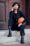 Fashion model, influencer and young woman with basketball posing on steps in urban city. Portrait of trendy, stylish and cool person with funky attitude, grunge personality and modern black clothes