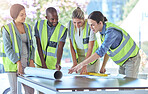 Industrial engineer team planning with blueprint paperwork in a meeting in an office or boardroom. Architect group of people collaborate on a building project working together on the design