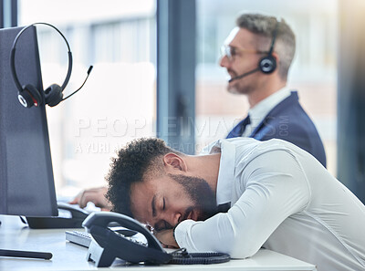 Buy stock photo Lazy, sleeping and tired call center agent at his table or desk at work overworked suffering from burnout. Exhausted young customer service employee asleep in the office or workplace