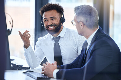 Buy stock photo Call center agent or telemarketing employee consulting a business man and talking about company growth. Happy male customer service employee in training with an HR manager at the office