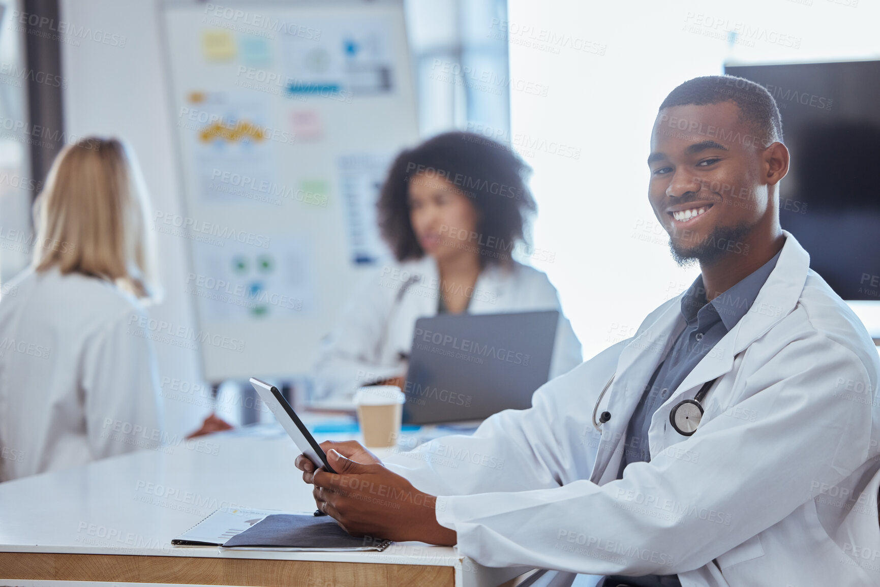 Buy stock photo Healthcare, medicine and a doctor on a tablet in a hospital boardroom or office after meeting or presentation. Happy medical worker with a smile, online at a table. Doctors on a coffee break at work.