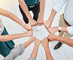 Teamwork, hands and collaboration with a team working together and standing in a huddle in the office. Solidarity, unity or trust and a group of staff with motivation and a goal for company success