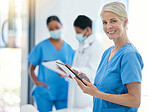 Doctor, smile and medical healthcare professional working on tablet for patient records in hospital building. Trust, consultation and medicine nurse worker with team of health experts