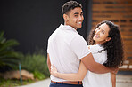 Portrait, love and couple happy in front of new home or house hug as they stand on driveway with a smile. Real estate, investment in future and property with man and woman spending time together.

