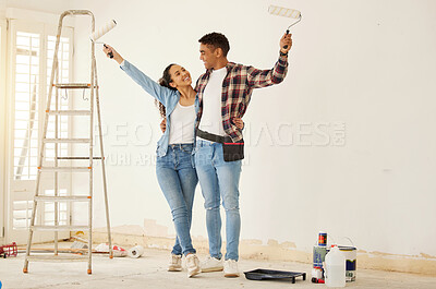 Buy stock photo Couple painting room for interior house renovation and home or property design project with smile, white wall background mockup. New home or apartment and happy painter people with DIY hardware