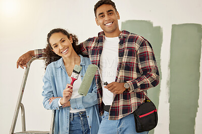 Buy stock photo Painting, love and home with a couple doing DIY, renovation and house remodel with a paintbrush and roller. Domestic relationship and teamwork with a man and woman ready to paint a room