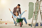 Couple with love smile happy on wheelbarrow while painting real estate property house, building or new home. Creative man and woman interior design, remodeling and work on renovation for room wall