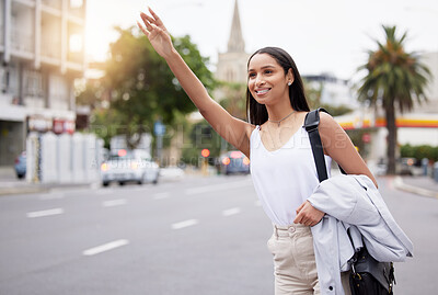 Buy stock photo Happy woman showing hand sign for a taxi while standing in a street in the city, business travel for a meeting or event. smiling female on her daily commute, gesture hail cab while on a trip downtown