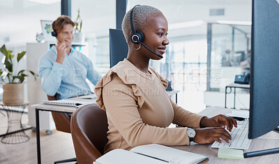 Buy stock photo Black call center, telemarketing, and customer service consultant typing on computer for database information a busy office. Contact us and crm agent offering support, help and service with a smile
