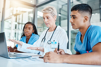 Buy stock photo Doctor teaching medical students on laptop in an office at the hospital while writing notes. Experienced professor with stethoscope training healthcare workers. Surgeons analyzing results on computer