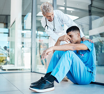 Buy stock photo Healthcare, stress and depression of male nurse or surgeon getting support from female doctor after breakdown or loss in a hospital. Medical worker sad, frustrated and tired after mistake or problem 