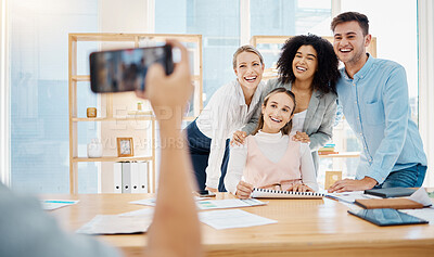 Buy stock photo Creative, business and corporate team taking a picture on a phone in the company conference room. Happy employees in a meeting consulting and planning a project. Work friends having fun at the office