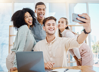 Buy stock photo Office selfie with happy corporate colleagues having fun and being goof, silly face expressions while bonding. Young, diverse work friends relaxing on a break, being playful after a productive day