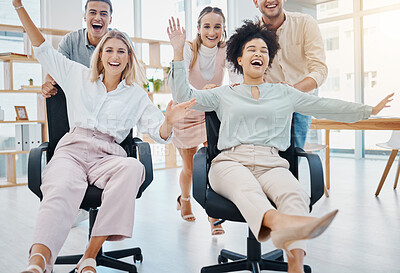 Buy stock photo Happy corporate colleagues having fun and being playful in an office, playing a game on chairs. Laughing friends silly and goofy, bonding and enjoying friendly team challenge after getting work done