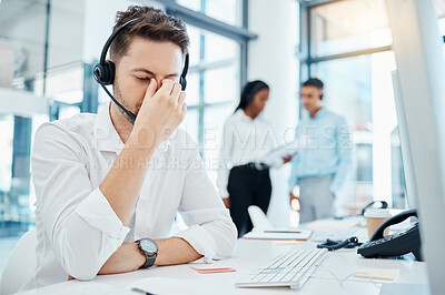 Buy stock photo Call center, headache and burnout of a man in customer service or support with eye strain at the office. Business male or employee in telemarketing suffering from head pain at the company workplace.