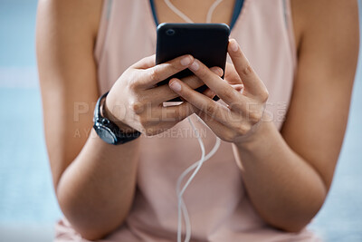 Buy stock photo Fitness app, phone and communication while typing on phone in sportswear to track progress on smart device with fast network. Close up hands of a woman listening to music or podcast during training