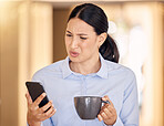 Business woman on phone reading an article online with an annoyed, stressed and disgusted face. Professional girl browsing on social media or the internet with smartphone at office with cup of coffee