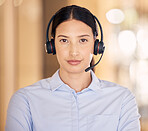 Telemarketing, contact us and customer service support agent ready to provide a good online service. Portrait of a serious sales consultant working at a call center. Tough agent looking ambitious