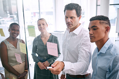 Buy stock photo Project manager, business team and diversity while planning for innovation with post it notes on a glass wall. Coach or leader sharing strategy for vision, mission and ideas in a marketing meeting