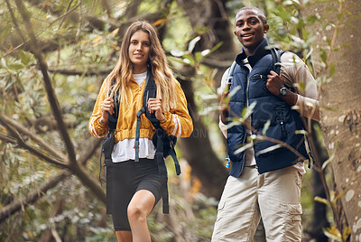Buy stock photo Portrait of interracial couple hiking in a nature forest environment or woods together in spring. Man and woman walking in sustainable outdoor ecology during trekking adventure or travel on holiday