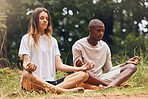 Yoga, interracial couple and meditation for zen and balance with black man and white woman sitting in lotus at a park in nature. Calm and content with holistic spiritual exercise and health training