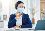 Call center agent giving online service with laptop, working in telemarketing and helping people with communication on pc in office at work. Latino customer support worker consulting with covid mask