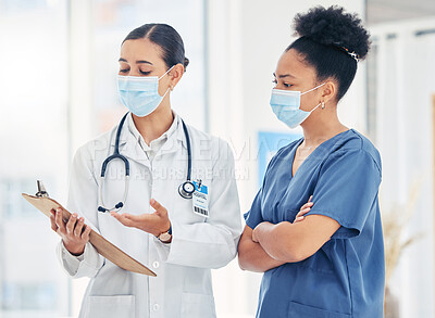Buy stock photo Doctor and nurse reading medical information paperwork with mask for safety from covid or corona virus in a hospital. Healthcare workers discuss and analyze pandemic data report in a clinic together