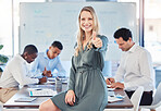 Portrait, thumbs up and happy business woman in office with workers busy in the background. Ceo or leader with a smile, teamwork and motivation with group planning strategy in corporate building